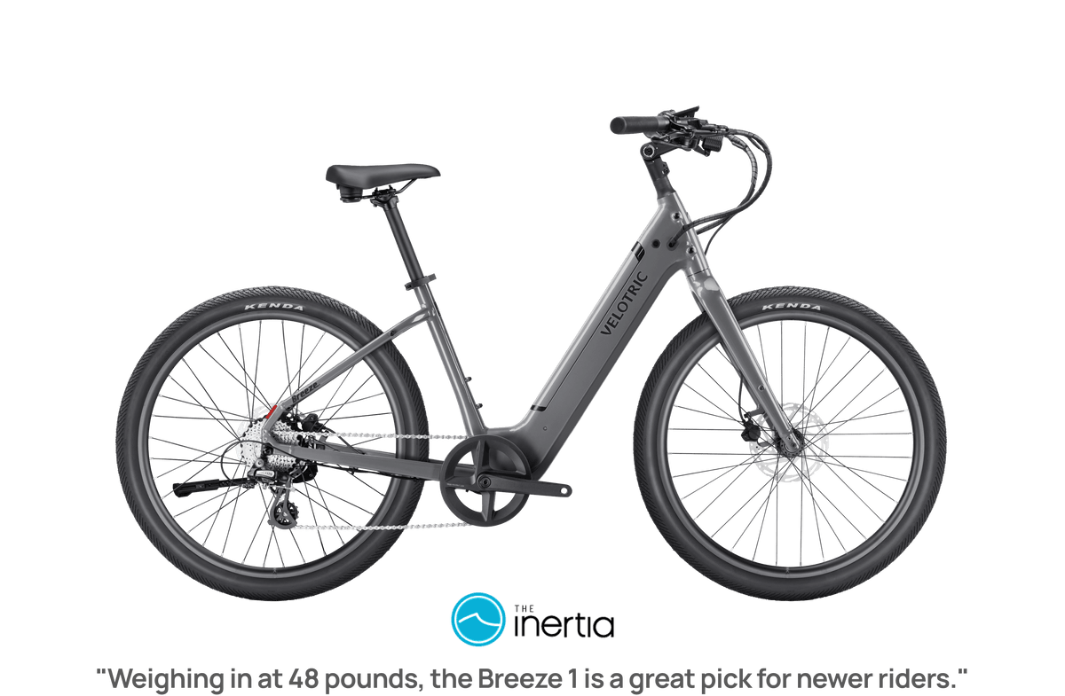 Slate gray Velotric Breeze 1 eBike side view, showcasing frame design, wheels, and handlebars against a plain background.