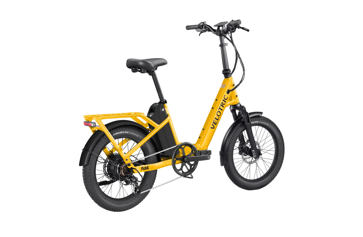 Velotric Fold 1 Plus electric bike in Mango color, folded for compact storage, shown against a plain background.