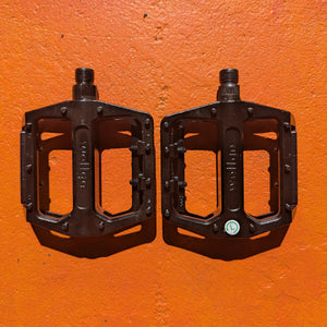 A pair of metal e-bike pedals in a modern, rugged style with a textured surface for enhanced grip and durability.