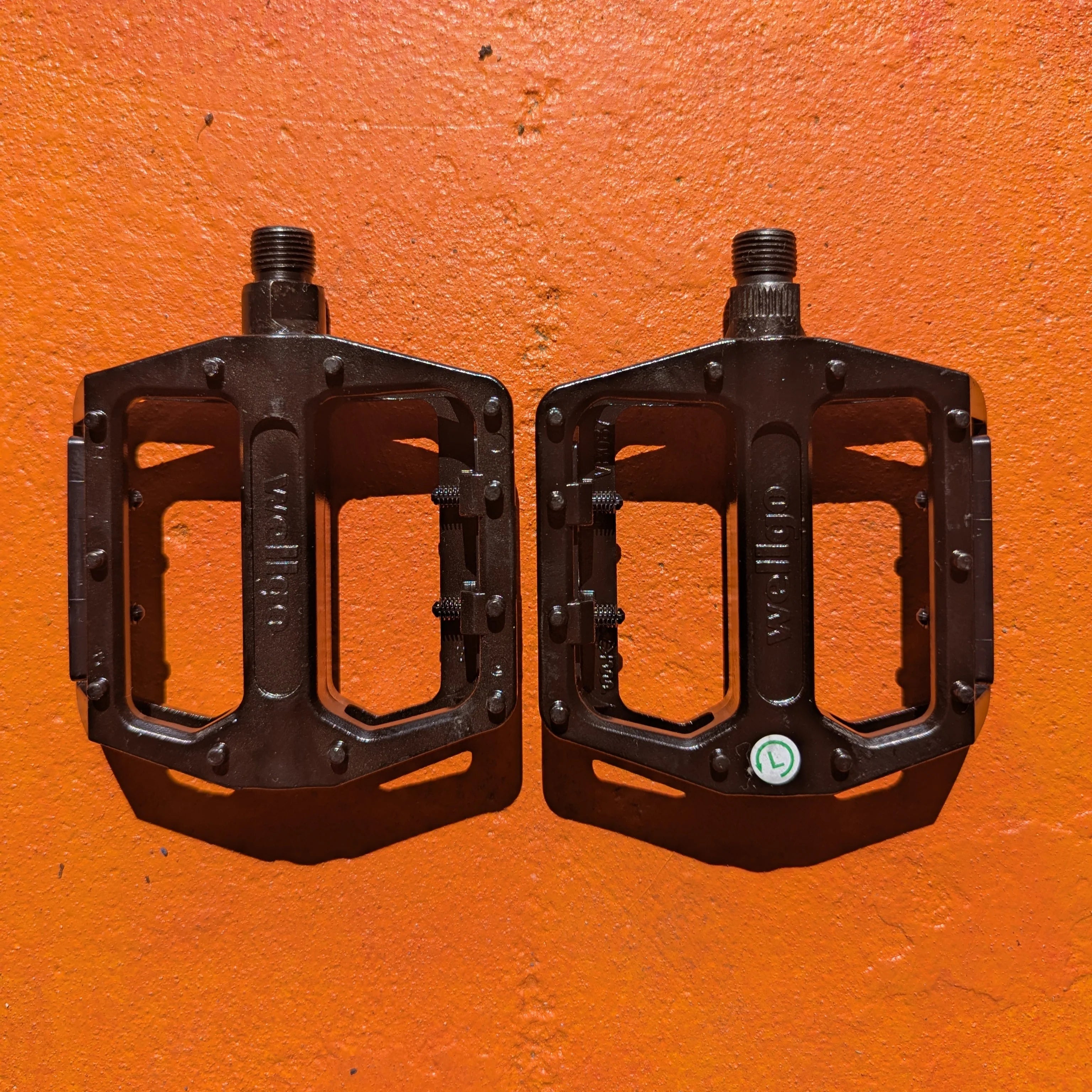 A pair of metal e-bike pedals in a modern, rugged style with a textured surface for enhanced grip and durability.