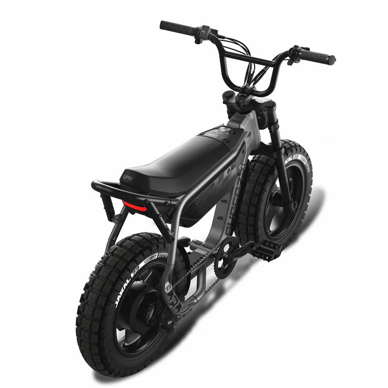 Side view of the eMOTO eBike Super73 MZFT in a showroom, highlighting its rugged frame, thick tires, and minimalist design.