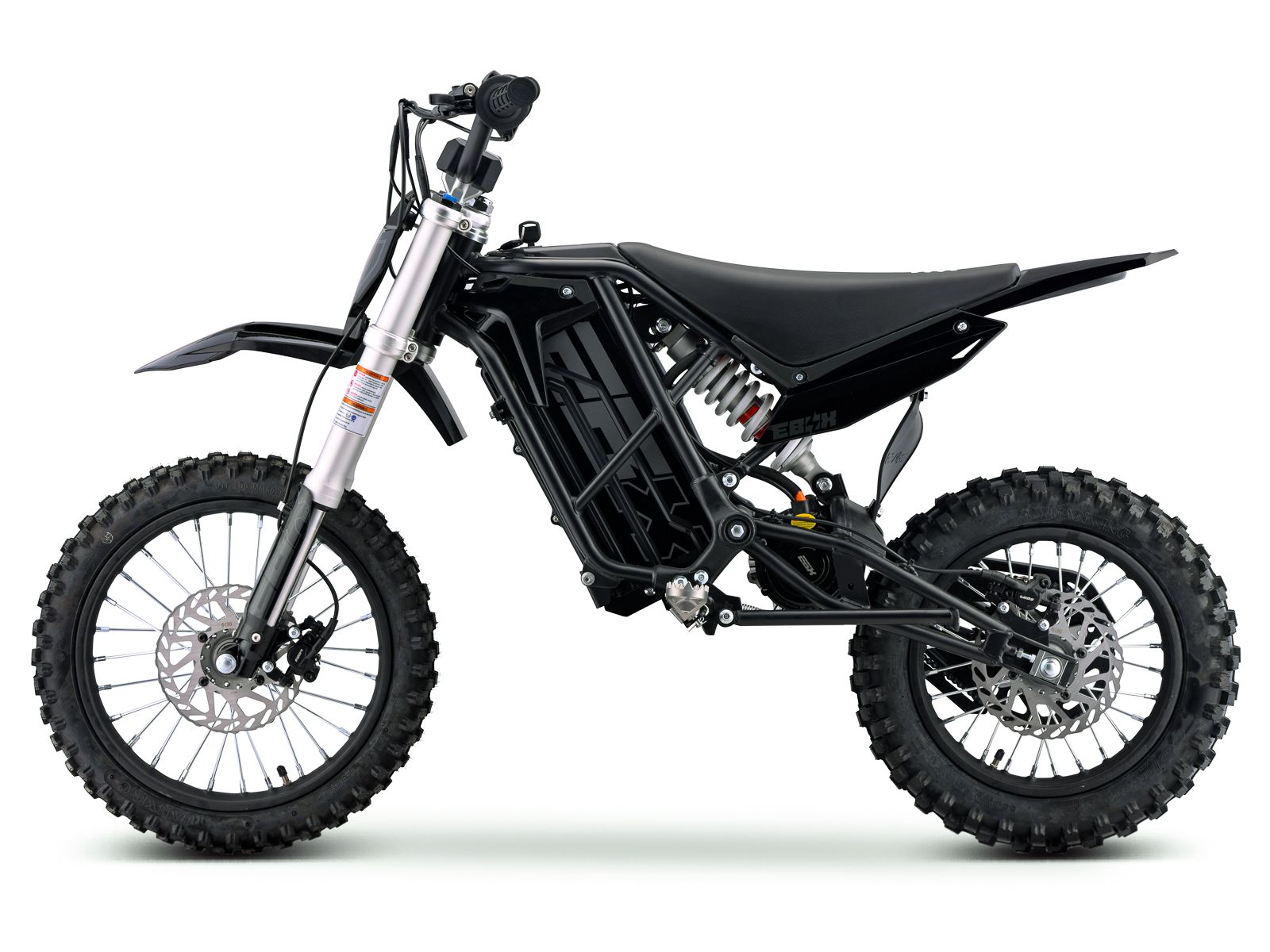Side view of the eMOTO Stomp Ebox V3 60 electric dirt bike, showcasing its frame, wheels, and suspension system.