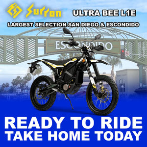Black eMOTO Surron Ultra Bee L1E 12.5kW electric motorcycle, side view, ready to ride, against a plain background.