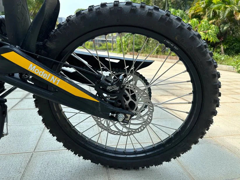 eMOTO FREEGO Natkie N1 Electric Dirt Bike, 4000W off-road eBike, side view, black and green design, rugged tires, outdoor background