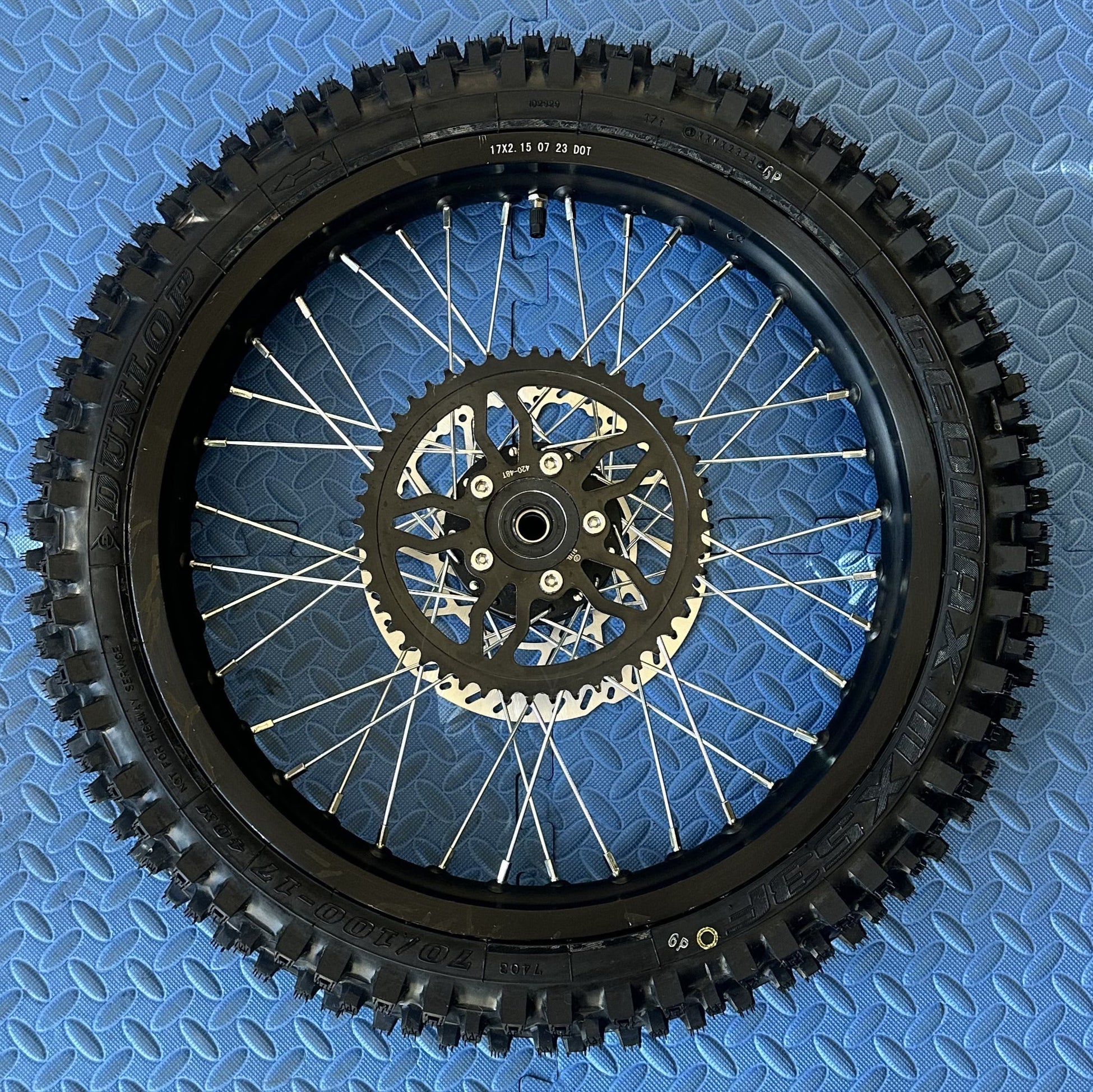 Product image of the eMOTO Surron eMoto Wheel Set featuring CST knobby tires, 17-inch front and 19-inch rear wheels, designed for electric dirt bikes; rotors and sprockets not included.