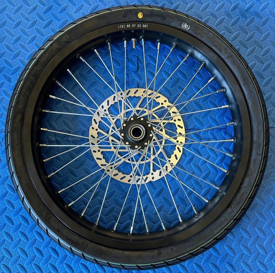Product image of a Surron eMoto CST Super Moto 17x1.6 front wheel and tire set for e-moto bikes, shown without rotor or sprocket.