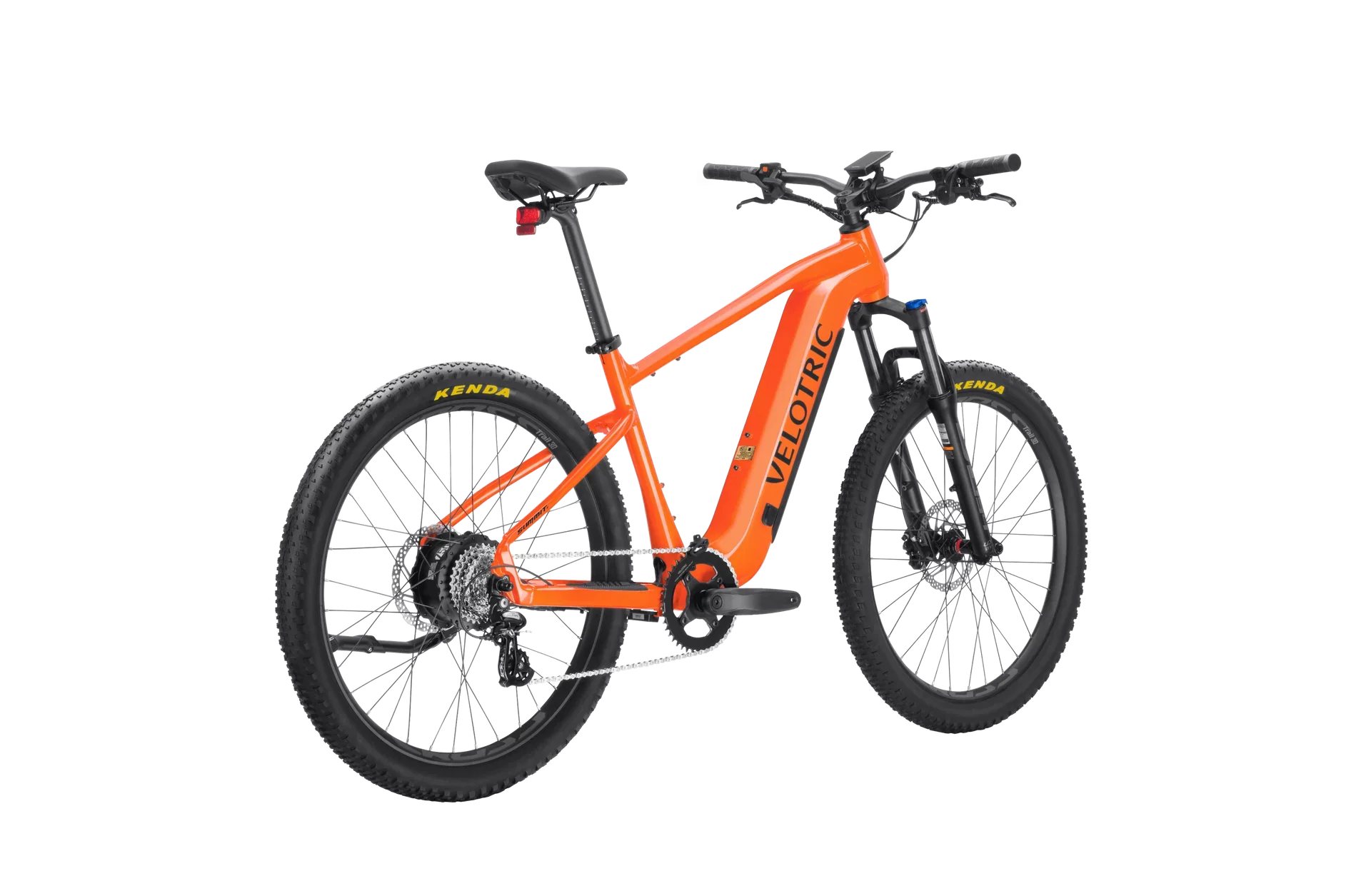 A side view of the Velotric Summit 1 eBike in a natural outdoor setting, showcasing its sturdy frame, front suspension fork, and thick all-terrain tires.