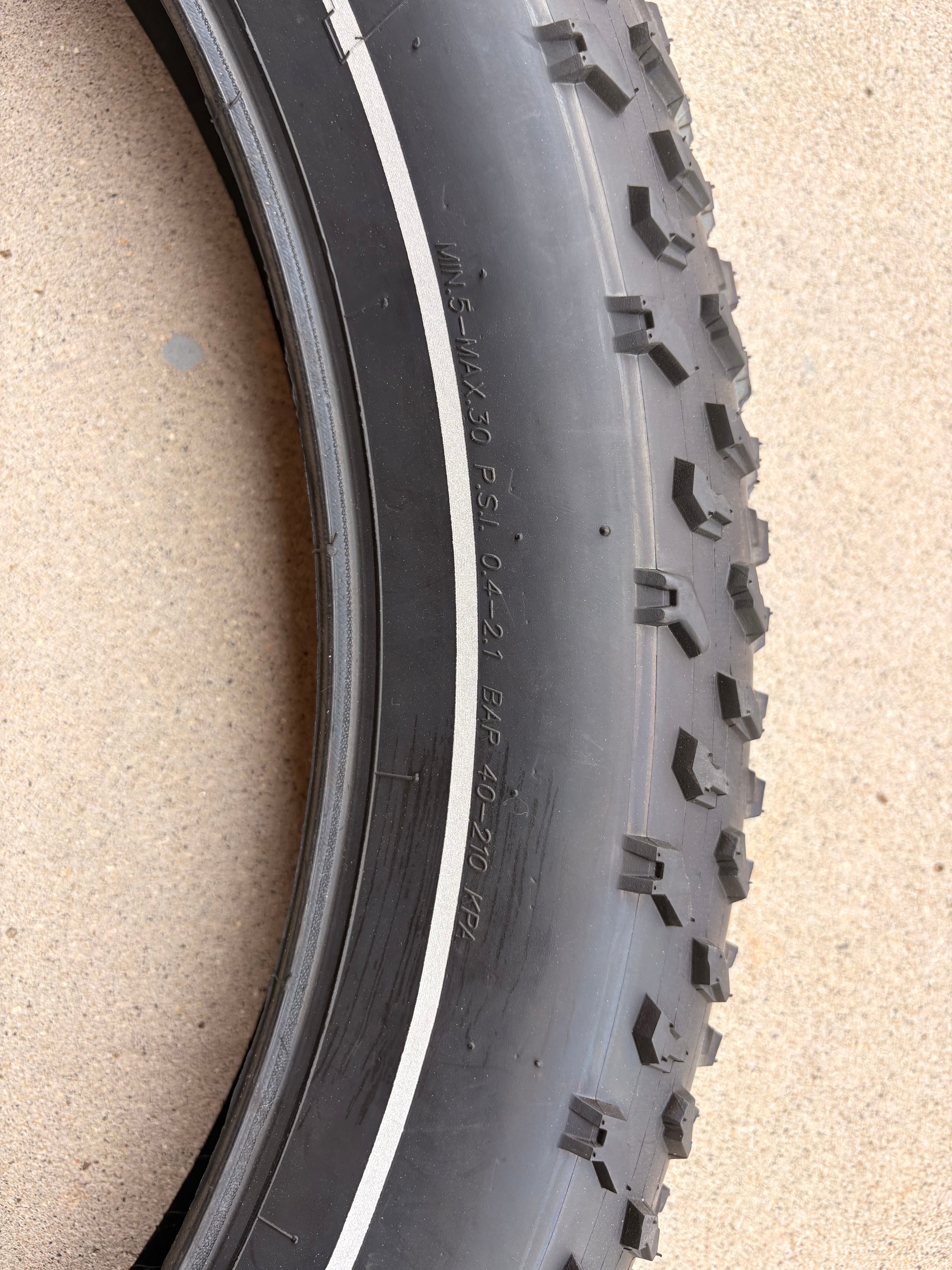 A 26x4 Kenda Krusade fat tire for eBikes with a reflective sidewall, shown in a product image.