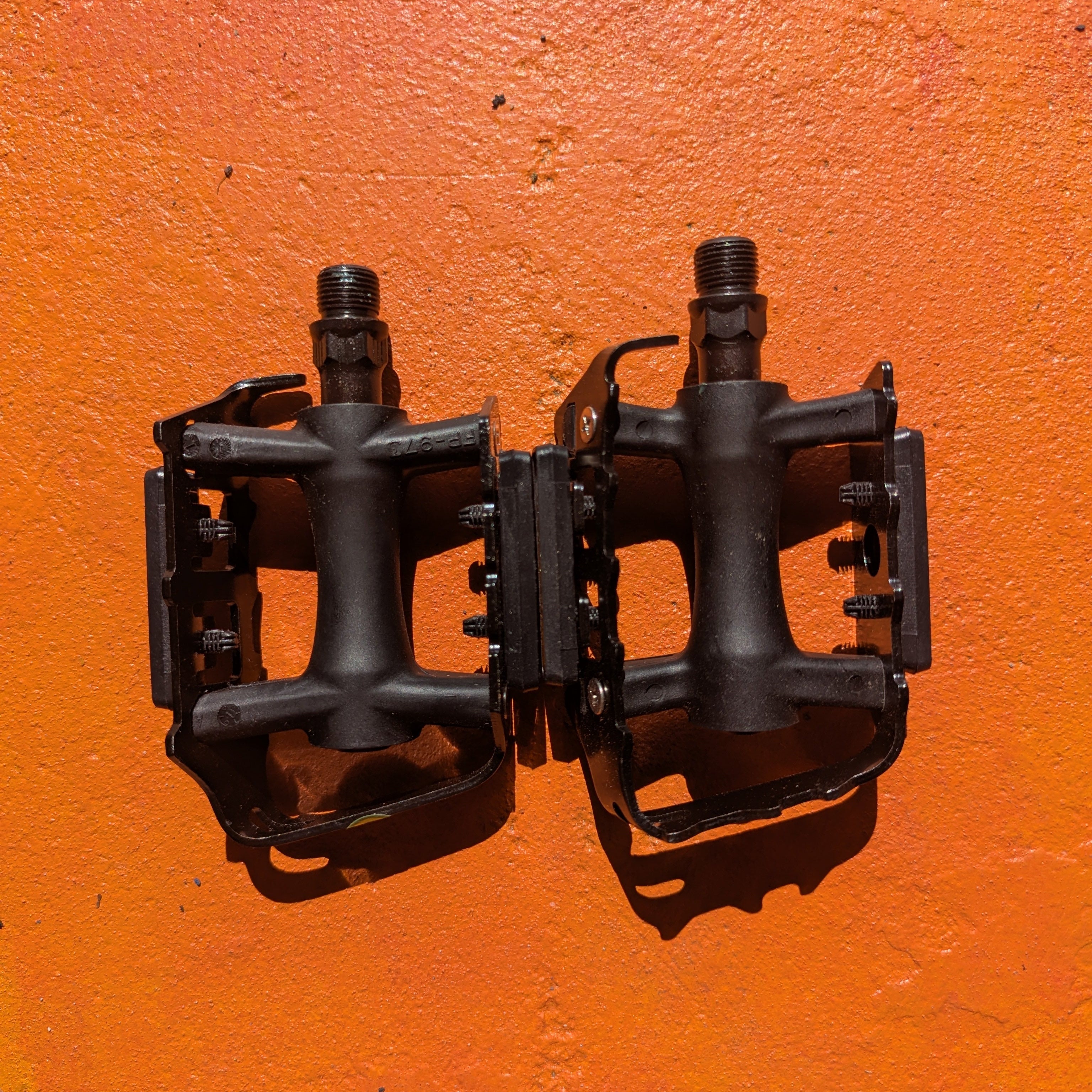Metal eBike pedals in Style 7 design, featuring a sturdy, textured surface and open frame for enhanced grip and durability, shown against a plain background.