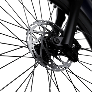 A black Segway Myon eBike parked on a city street, showcasing its sleek frame, integrated battery, and modern design.