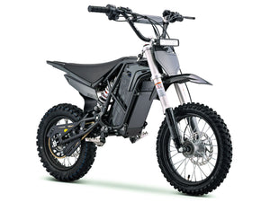 Side view of the eMOTO Stomp Ebox V3 72 RS electric dirt bike in a studio setting, showcasing its frame, wheels, and suspension components.