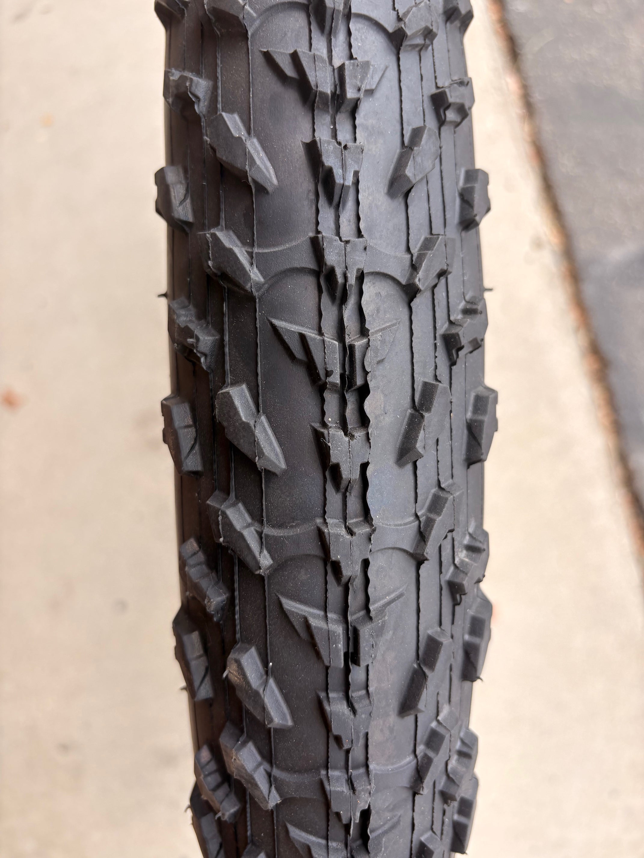 Electric fat tire bike featuring 26x4 inch Kenda Krusade tires, side view, black frame, photographed against a white background.
