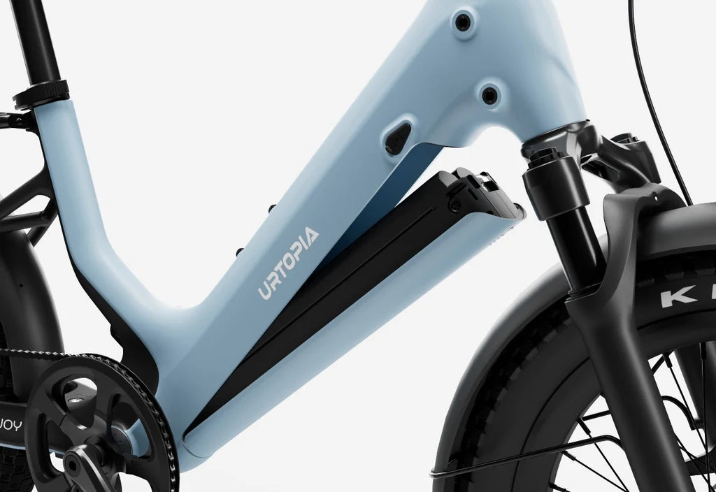 Side view of the Urtopia Carbon Joy eBike in Glacier Blue, showcasing its lightweight carbon frame, sleek design, and integrated battery against a plain background.