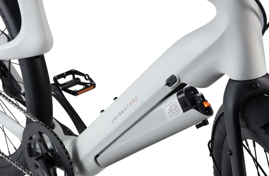 Side view of the Urtopia Carbon 1 Pro eBike in creme color, showcasing its sleek carbon fiber frame, integrated battery, and minimalist design against a plain background.