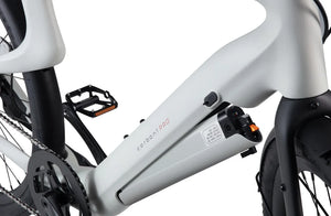 Side view of the Urtopia Carbon 1 Pro eBike in creme color, showcasing its sleek carbon fiber frame, integrated battery, and minimalist design against a plain background.