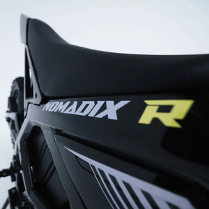 A folded blue Nomadix towel with Juiced Powersports branding displayed on a white background.