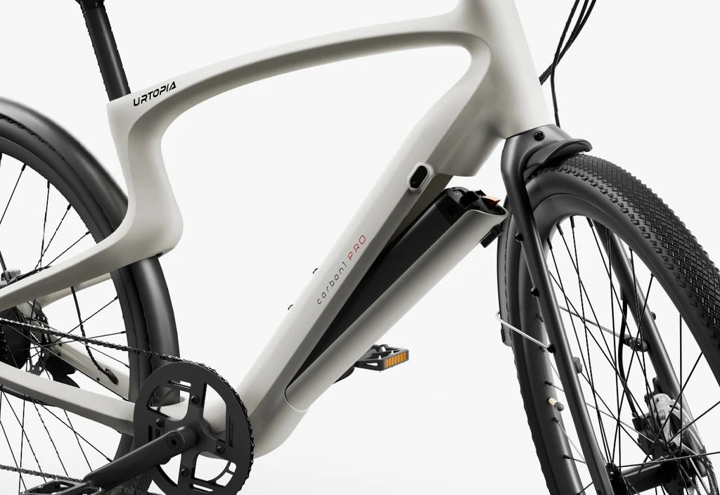 Side view of the Urtopia Carbon Classic eBike in creme color, showcasing its lightweight carbon frame, sleek design, and integrated components against a plain background.
