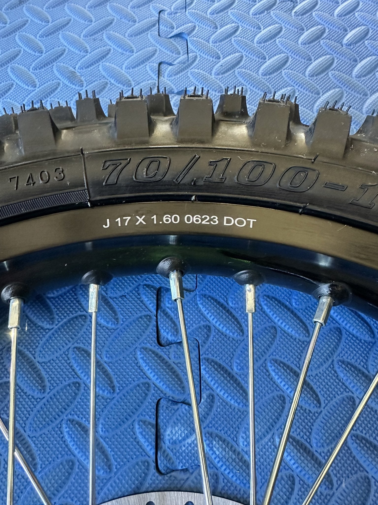 Product image of the eMOTO Surron eMoto Wheel Set featuring a CST knobby 17-inch front wheel and tire set for electric dirt bikes, shown without rotor or sprocket.