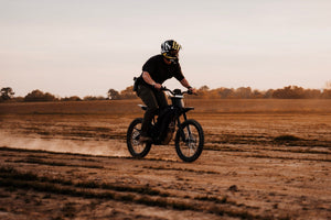 eMOTO eRide Pro SS 2.0 electric dirt bike in black, featuring 19x3 off-road tires, robust frame, and sporty design, displayed on a white background.