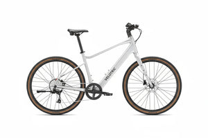 Side view of the Velotric Tempo eBike in a studio setting, showcasing its step-through frame, rear rack, and upright handlebars.