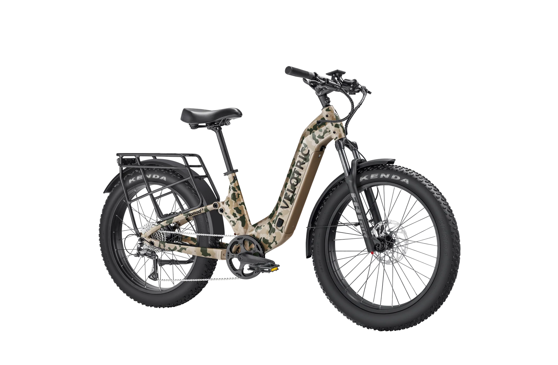 Velotric Nomad 2X eBike in multi-terrain camo color, shown on a rugged outdoor trail with thick tires and sturdy frame designed for off-road riding.