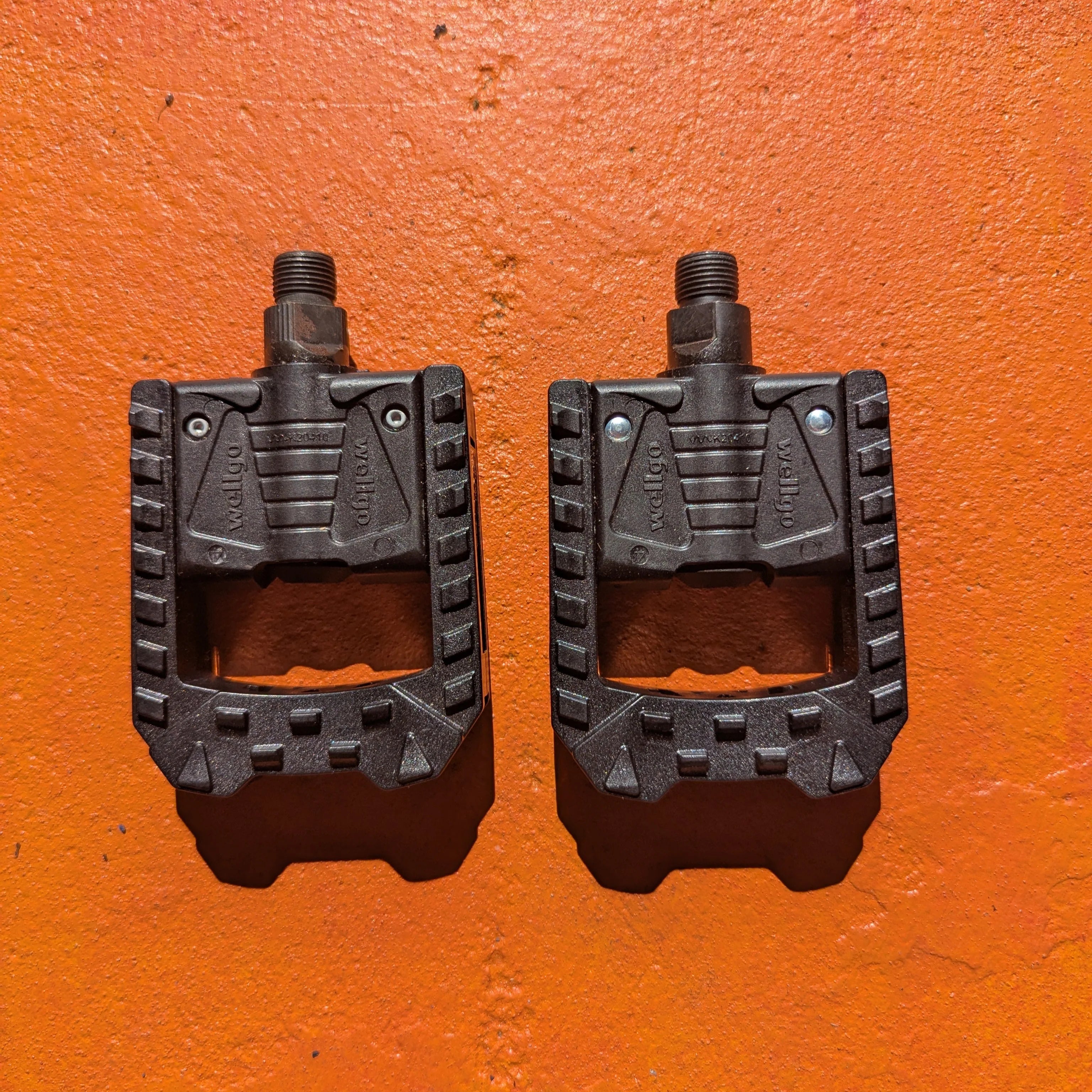 Black nylon folding e-bike pedals with textured surface and compact, space-saving design.
