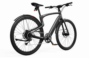 Side view of the Urtopia Carbon 1 Pro eBike in matte black, showcasing its sleek carbon fiber frame, integrated display, and minimalist design against a plain background.