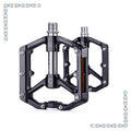 Black aluminum bicycle pedals with a silver accent, product code 7884746, displayed on a white background.