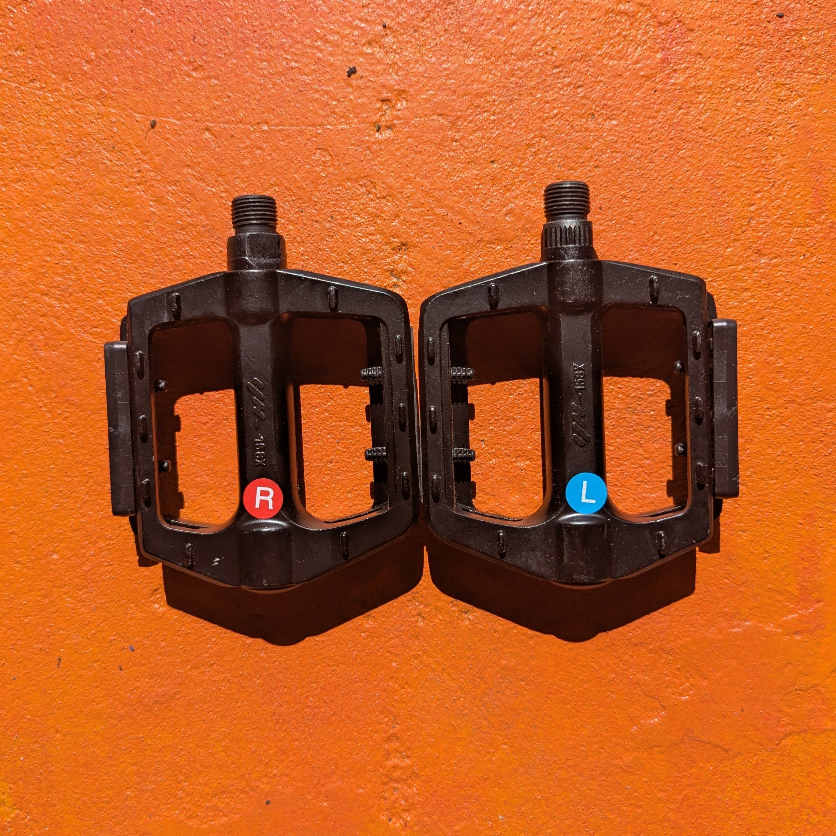 A metal bicycle pedal in Style 2 design, featuring a sleek, durable construction with textured grip surface and visible mounting holes.