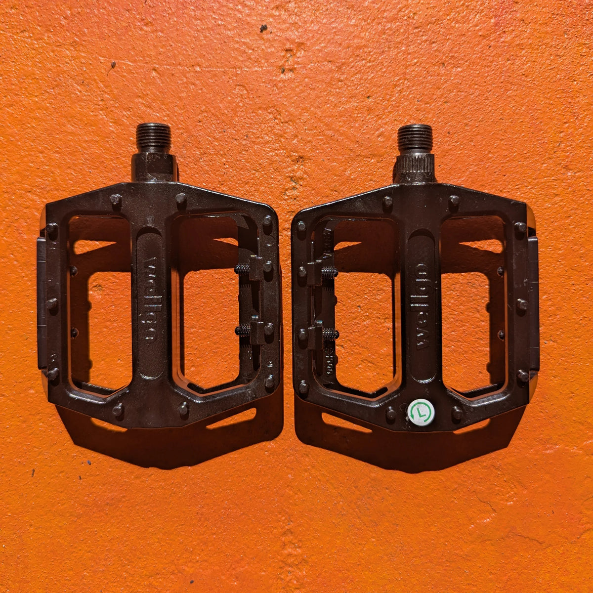 A pair of metal e-bike pedals in a modern, rugged style with a textured surface for enhanced grip and durability.