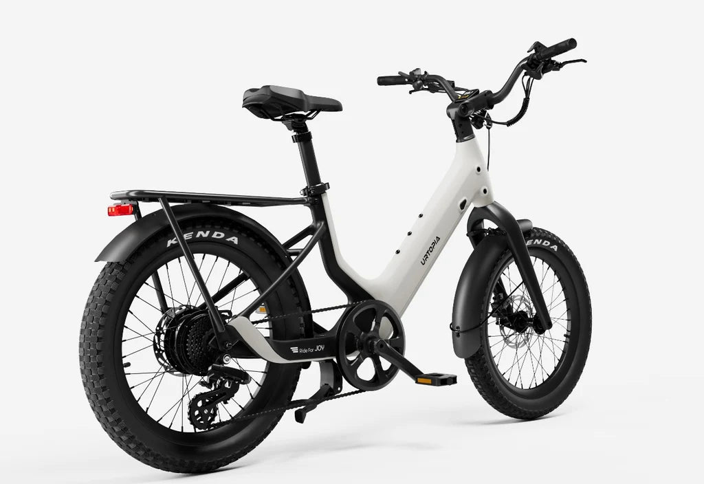 Side view of the Urtopia Carbon Joy Ultra eBike in Creme color, showcasing its sleek carbon frame, integrated battery, and modern design against a plain background.