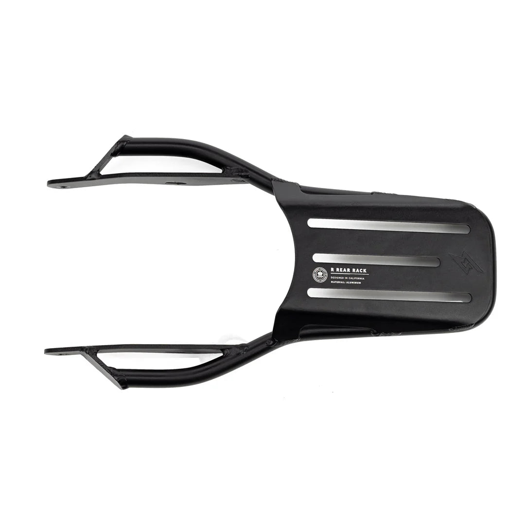 Side view of a Super73 R-Series electric bike equipped with a sturdy black rear rack, mounted above the back wheel, designed for carrying cargo or accessories.