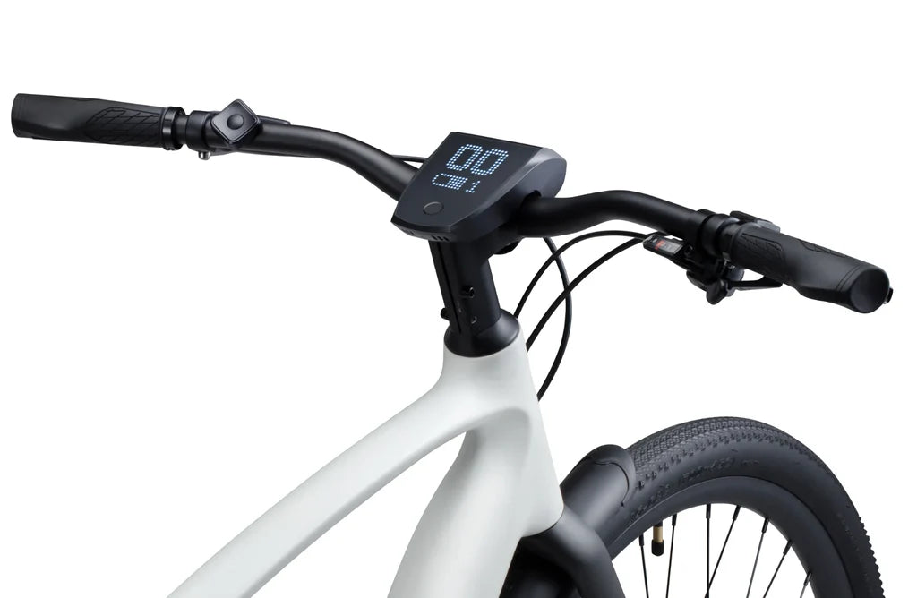 Side view of the Urtopia Carbon 1 Pro eBike in creme color, showcasing its lightweight carbon frame, sleek design, and integrated components against a plain background.