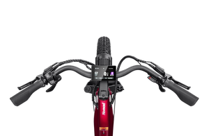 Side view of the Velotric Nomad 2 eBike in yellow, showing its fat tires, step-through frame, and rear cargo rack against a white background.