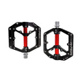 Black and red alloy eBike pedals with a textured surface and durable construction