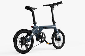 Side view of the Urtopia Carbon Fold 1 eBike in a folded position, showcasing its compact carbon fiber frame and modern design.