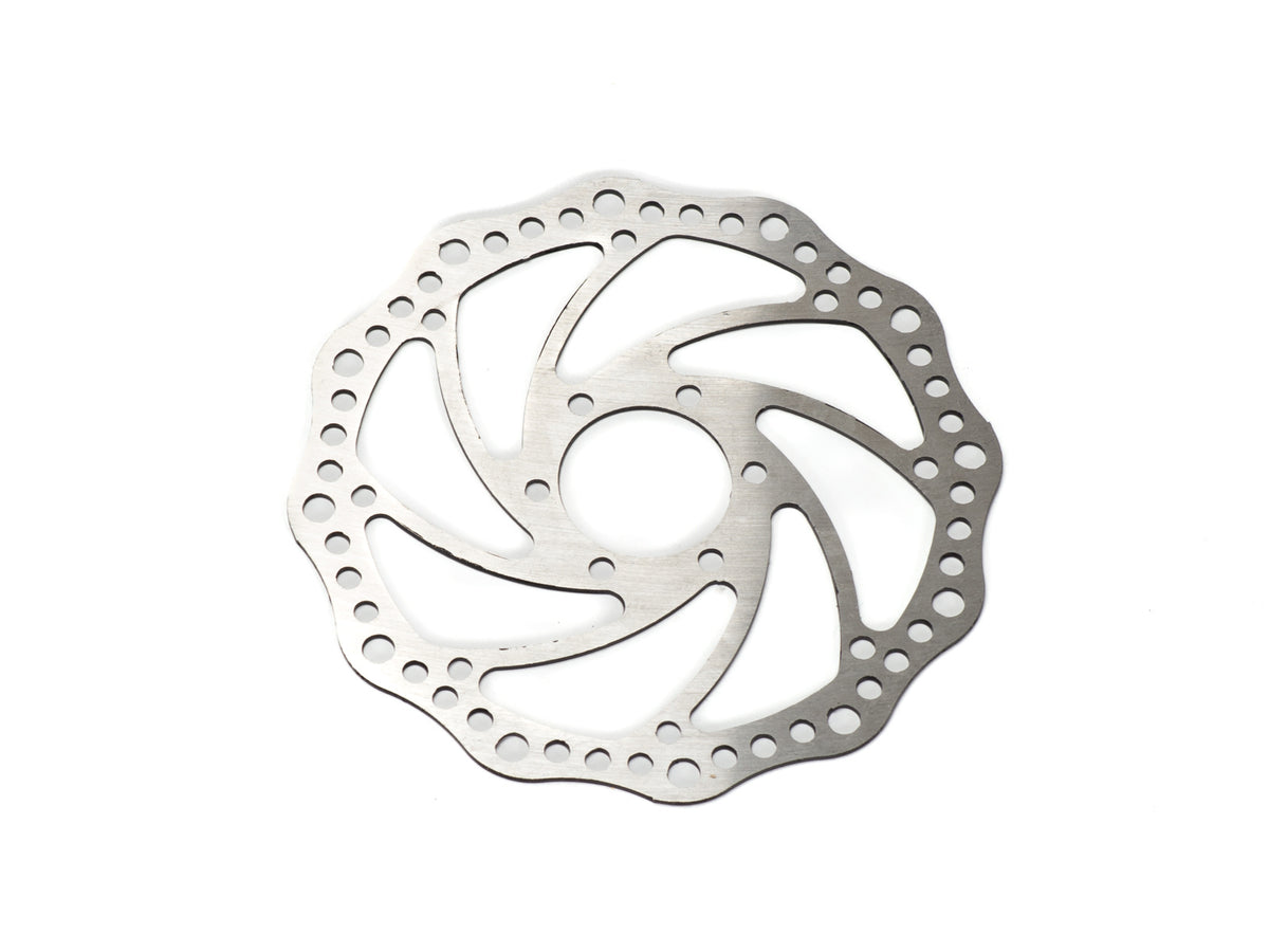 Close-up view of the Stomp Ebox Dragster brake rotor, showing the circular metal disc with precision-drilled holes and a vented design for enhanced braking performance.