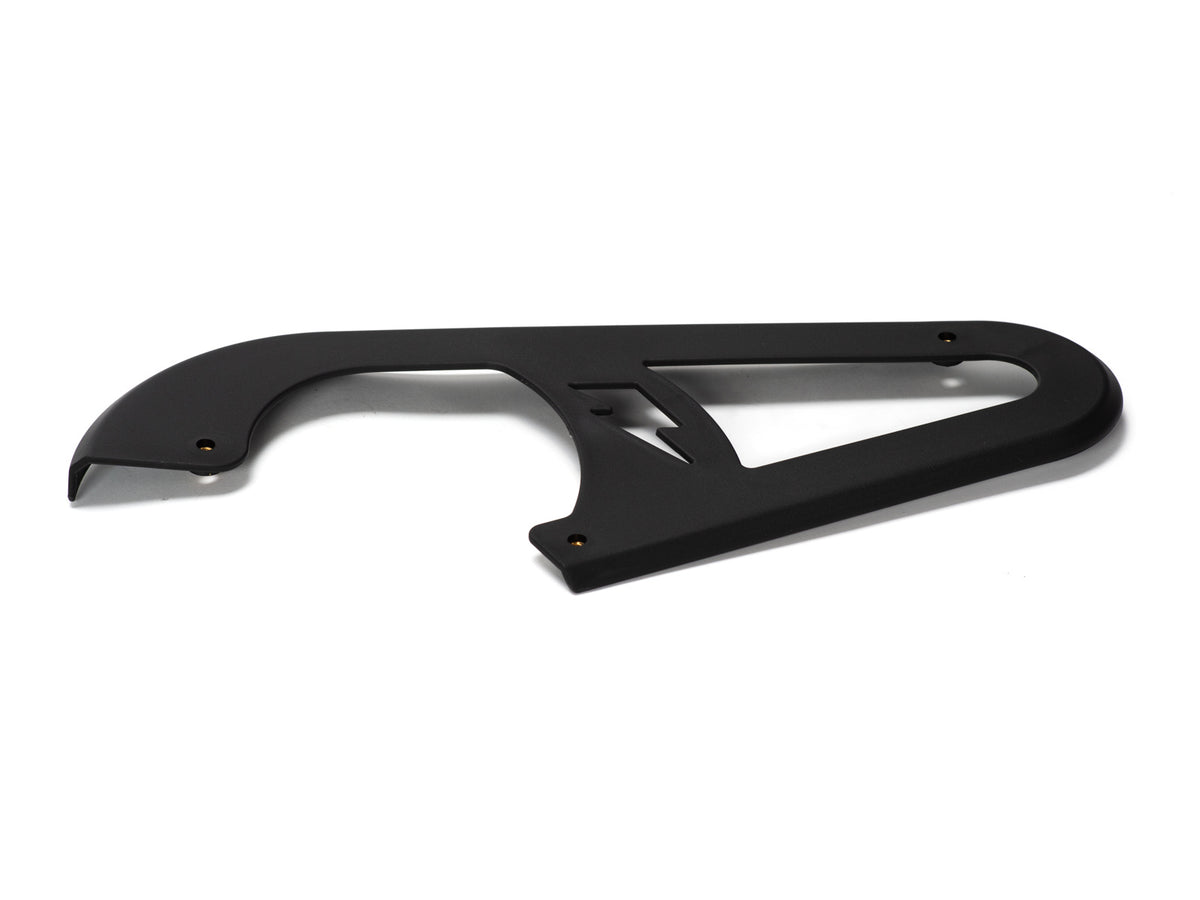 Stomp Ebox Dragster chain guard, black metal component mounted on a motorcycle frame, shown from a side angle against a white background.
