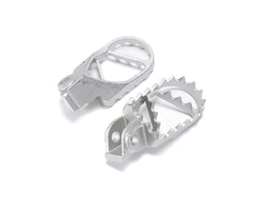 Stomp Ebox Dragster stainless steel foot pegs, angled view showing textured surface and mounting bracket.