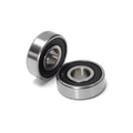 Close-up view of Stomp Ebox Dragster wheel bearings, showing two metal ball bearings on a white background.