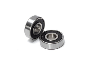Close-up view of Stomp Ebox Dragster wheel bearings, showing two metal ball bearings on a white background.
