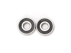 Close-up view of Stomp Ebox Dragster wheel bearings, showing metal bearing components arranged on a white background.