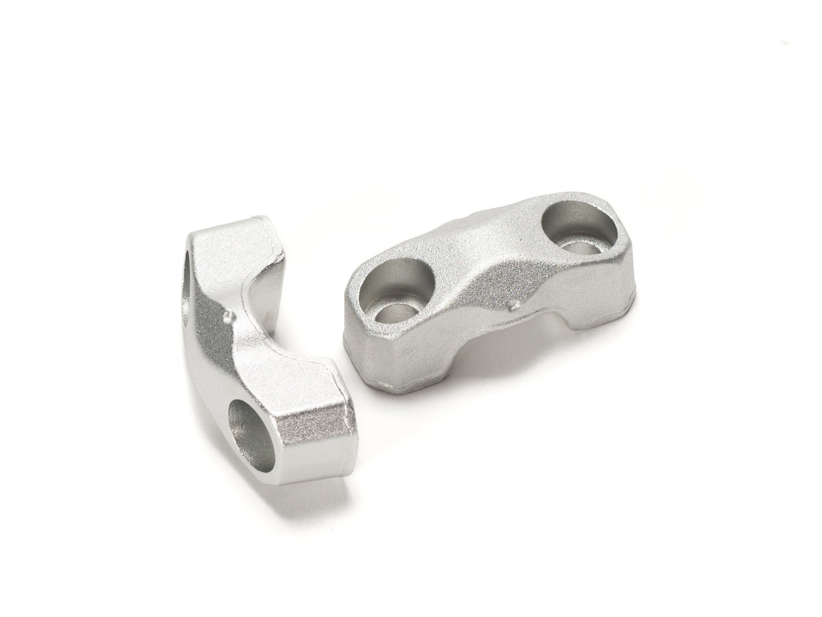 Close-up view of Stomp Ebox handlebar risers installed on a motorcycle, showing the black anodized finish and secure mounting hardware.