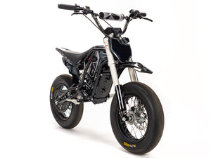 Stomp Ebox Megalith Graphics Kit displayed on a dirt bike, showcasing bold geometric patterns in black, white, and neon yellow with the Stomp logo on the side panels.