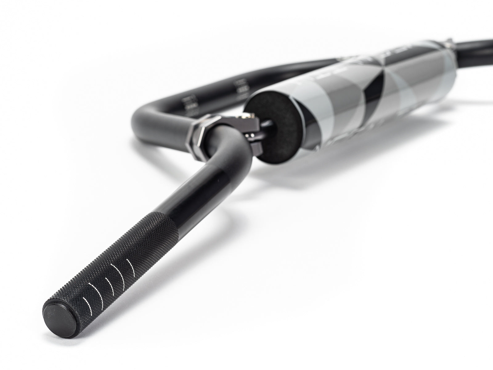 Stomp Ebox Megalith Pitspeed 7075 handlebar, close-up view showing black anodized finish and ergonomic design, photographed against a white background.