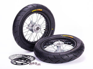 Stomp Ebox Supermoto Wheel Set 12-12, black alloy wheels with silver spokes, displayed side by side on a white background.