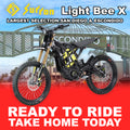 Black Sur-Ron Light Bee X eMOTO electric bike, model R2R, side view, outdoors.