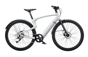 A creme-colored Urtopia Carbon 1 Pro eBike displayed from a side angle, showcasing its lightweight carbon frame, integrated battery, and sleek modern design.