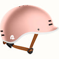 Rose gold Retrospec Remi eBike helmet, side view, with adjustable straps and ventilation holes