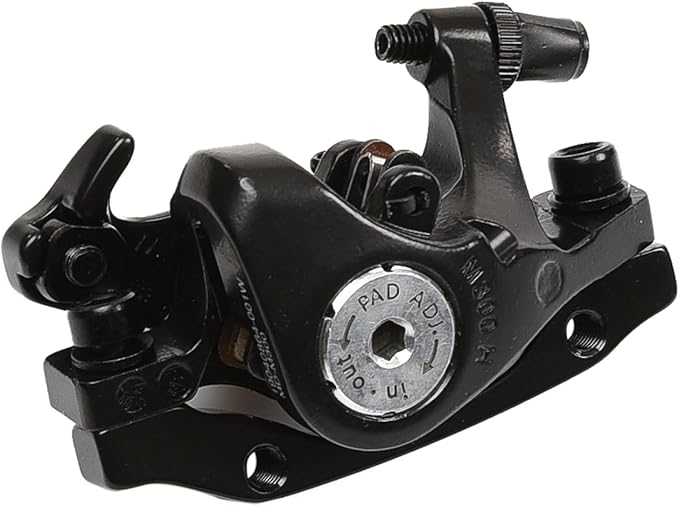 Close-up of a Tektro bicycle brake lever mounted on a handlebar, showing the black metal lever and adjustment screw.